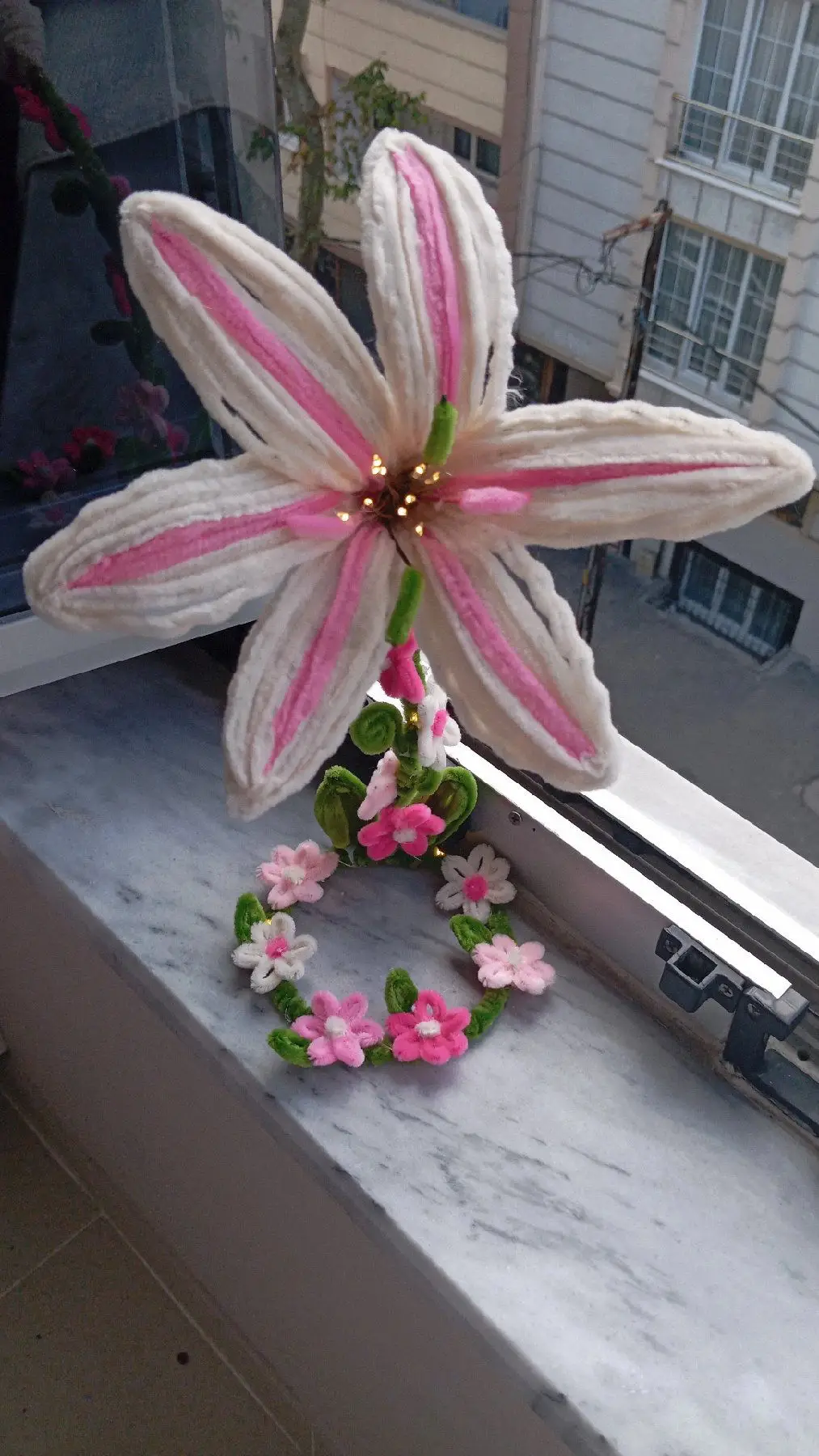 El yapımı pembe çiçek aranjmanı ışıklı